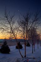 Crescent moon at dawn over snowy field, Honey Pot, Hadley, Mass.