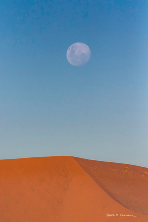 Moon over a red sand dune at Sossusvlei